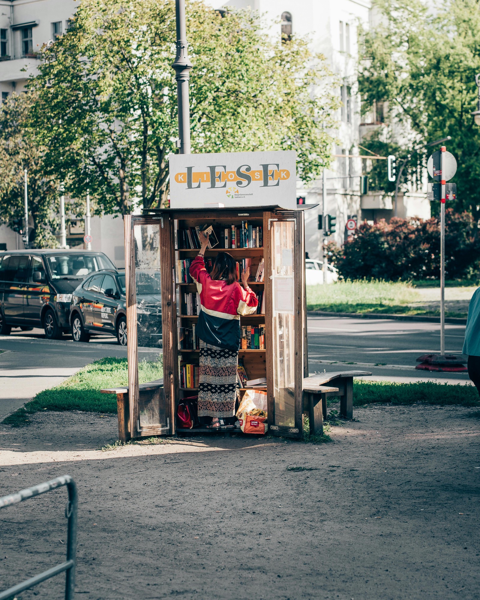 Street scene in a Berlin neighborhood with cafe terraces and bikes