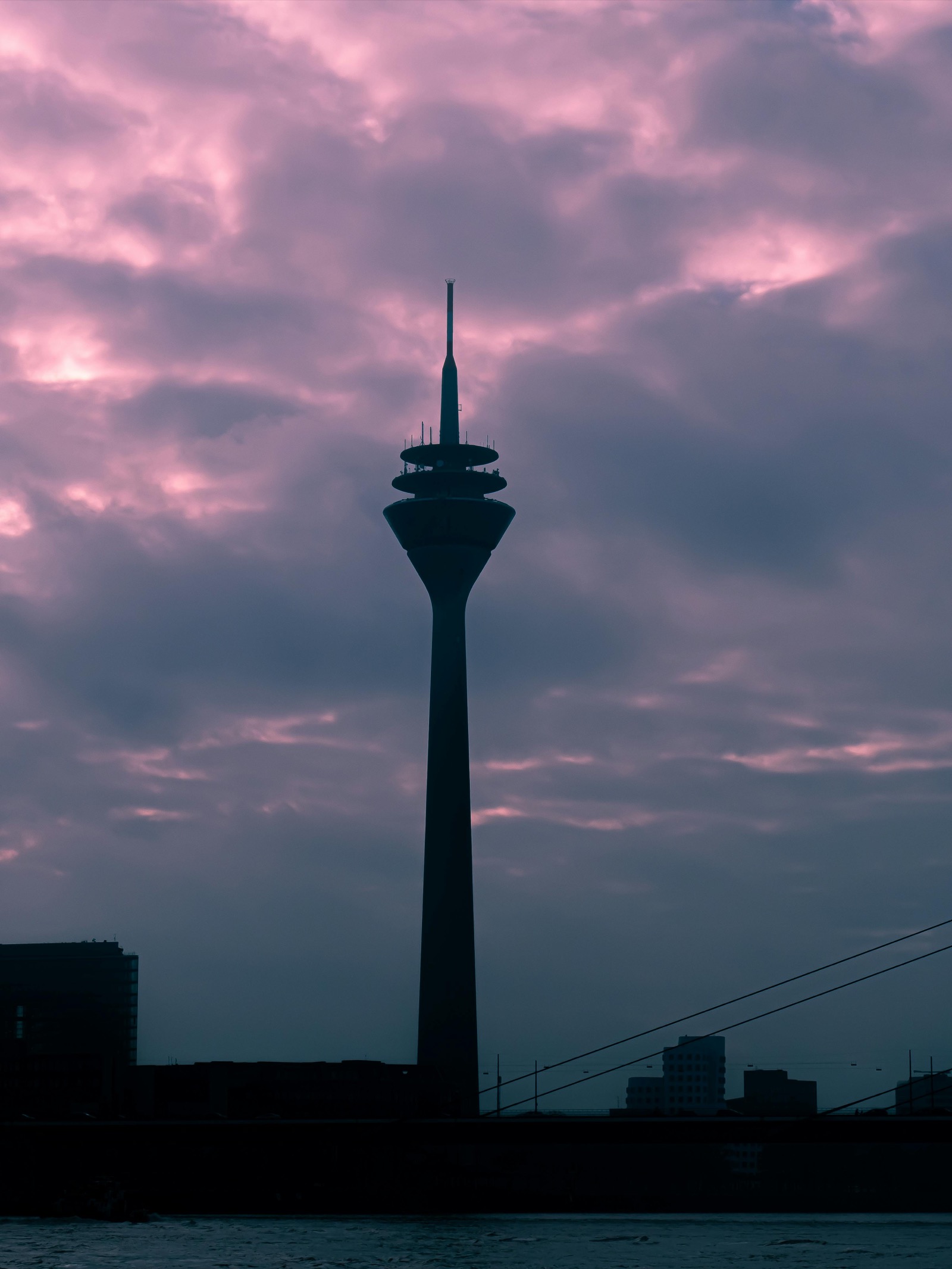 A residential street in Dusseldorf's Flingern district with colorful facades, outdoor cafes, and bicycles